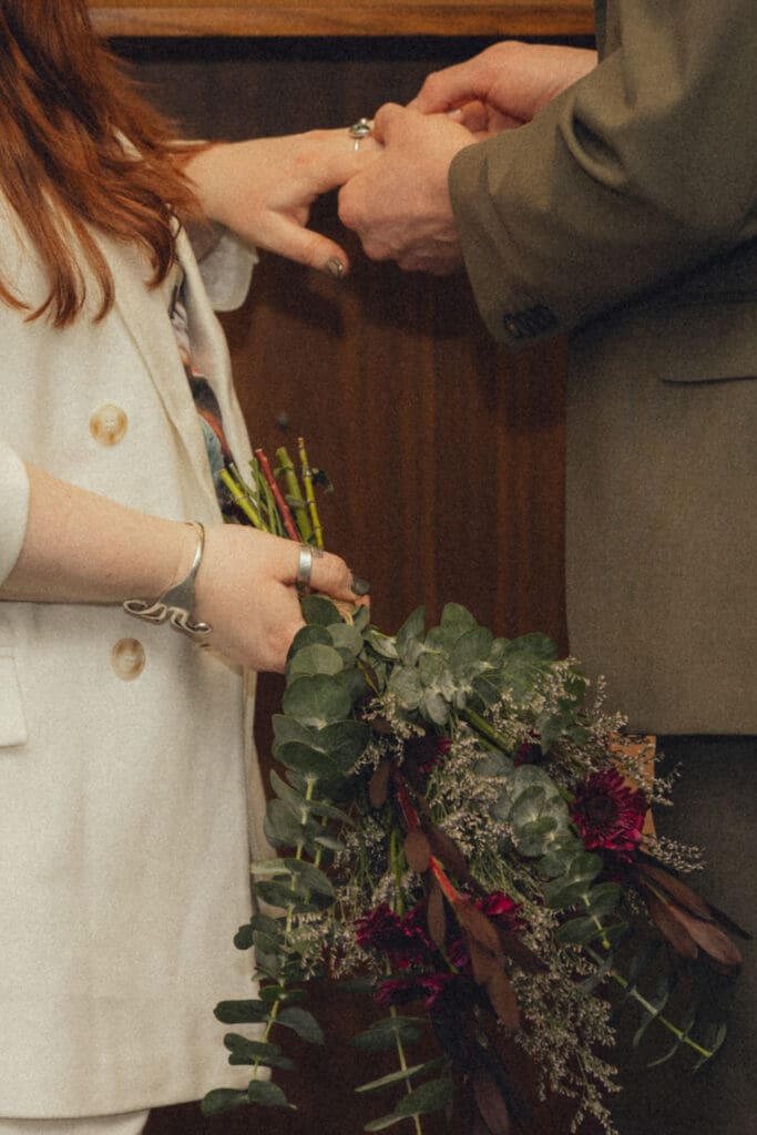 Couple exchanging rings at their manhattan city hall elopement