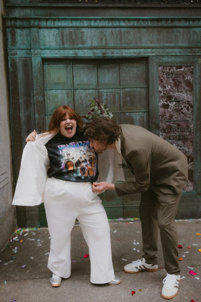 Couple laughing while bride shows her custom dog graphic t-shirt