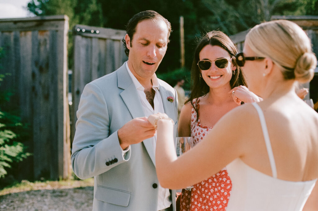 Guest looking at the bride's ring during cocktail hour