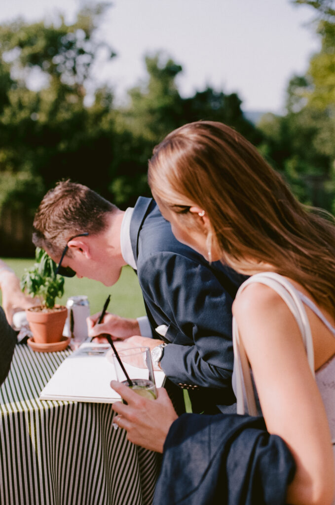 Wedding guests signing the guest book