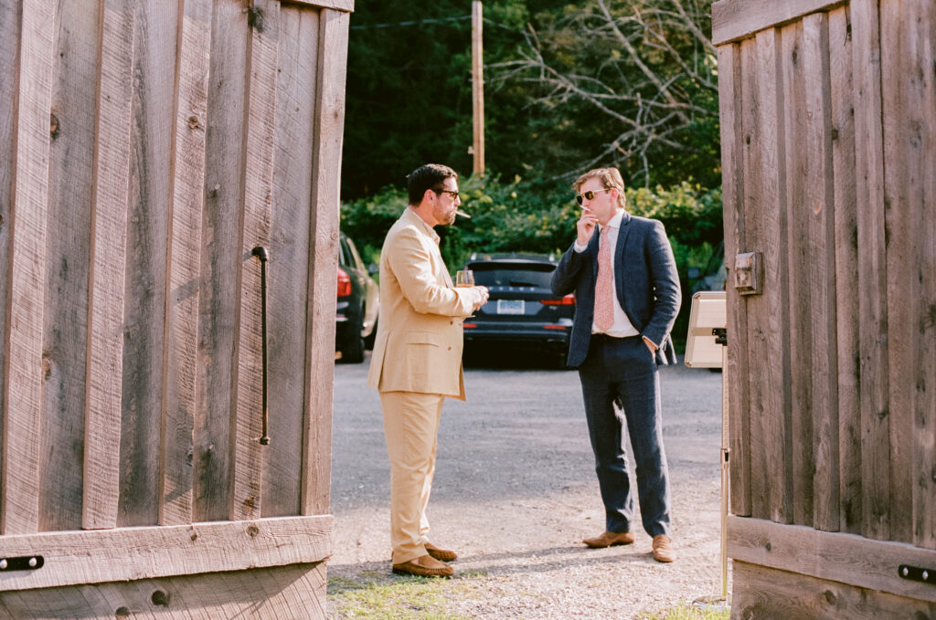 Wedding guests smoking cigarettes during the reception