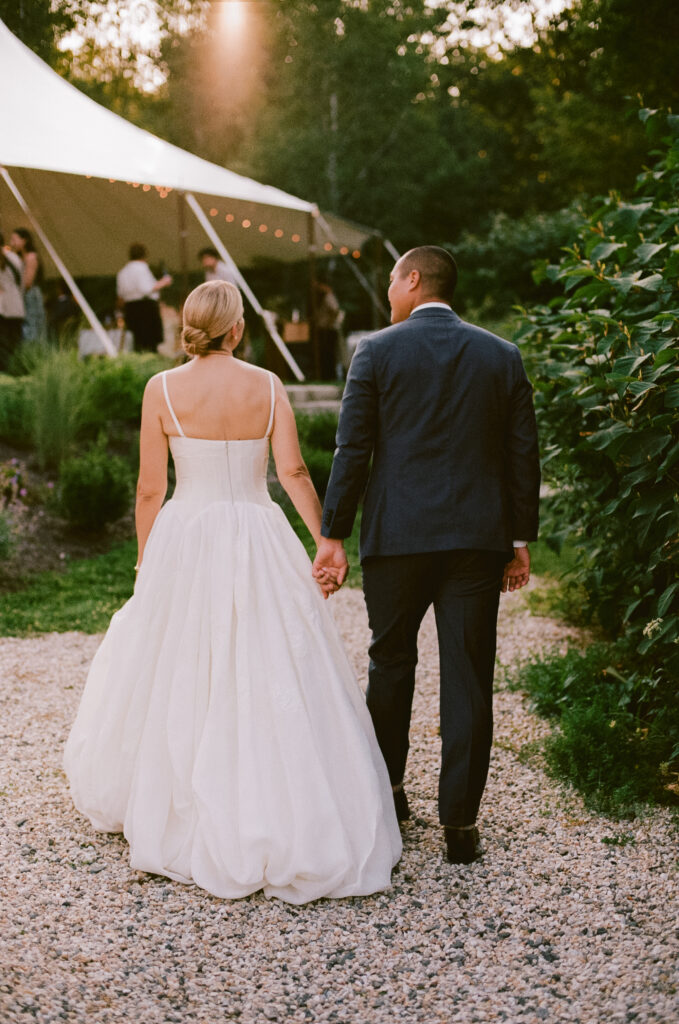 Bride and groom walking in to the reception