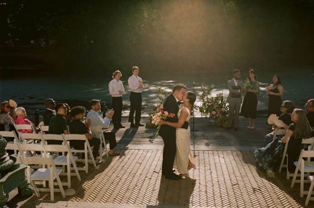 Bride and groom kissing during the ceremony at a prospect park boathouse wedding