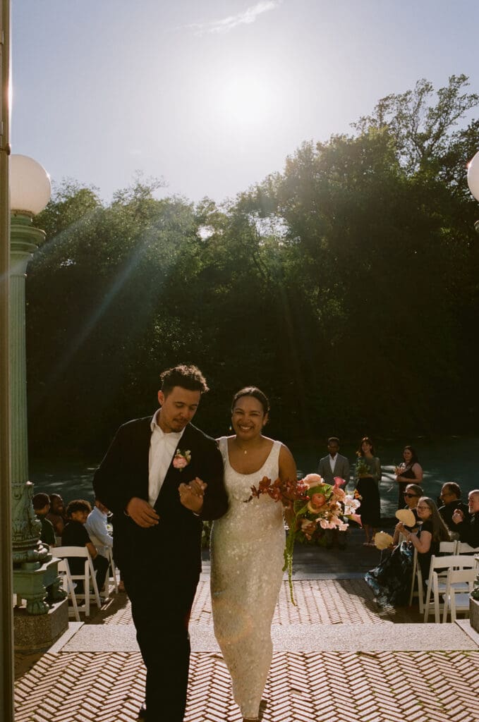 Bride and groom walking back down the aisle after the ceremony at a prospect park boathouse wedding