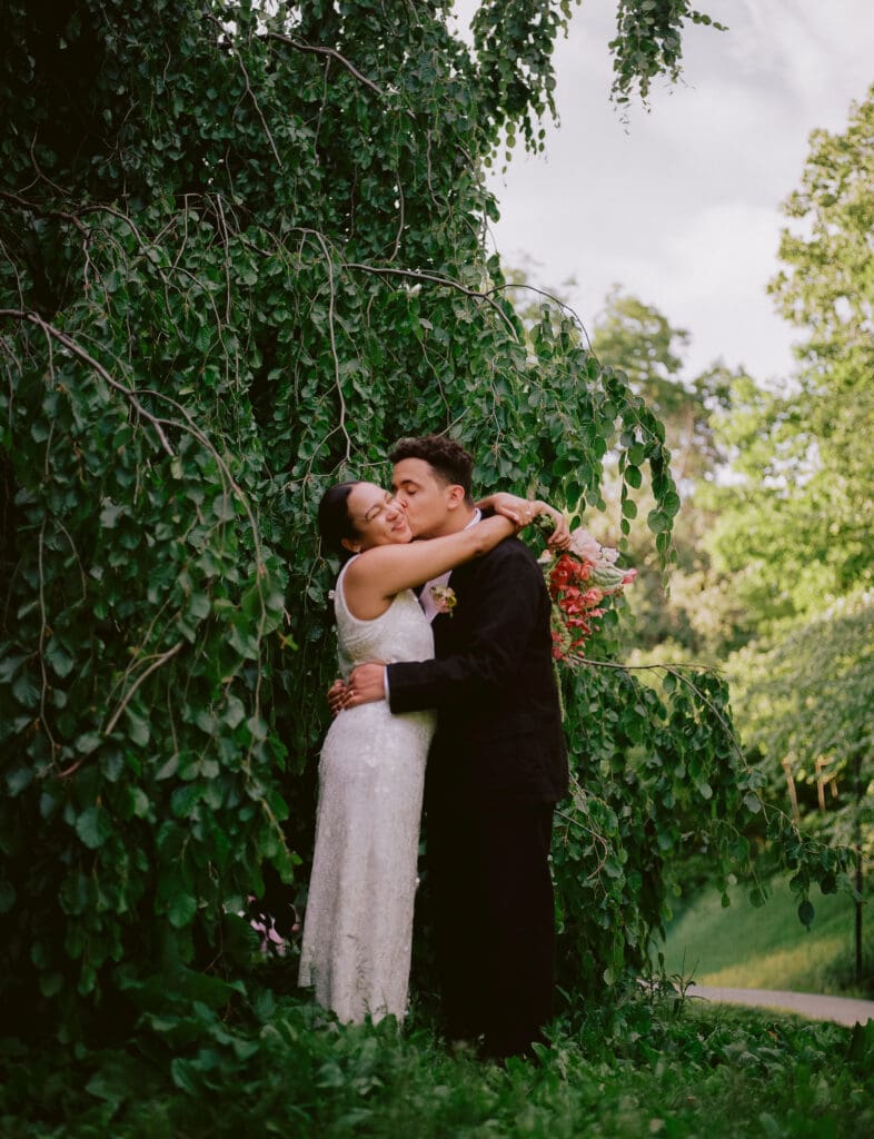 Bride and groom portrait in front of a tree at their prospect park boathouse wedding