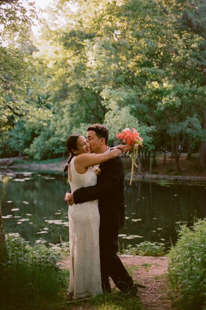 Bride and groom portraits in front of the lake at their prospect park boathouse wedding