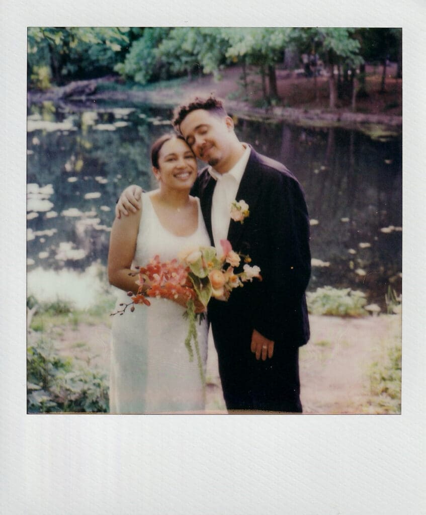 Polaroid of the bride and groom in front of the lake at the prospect park boathouse