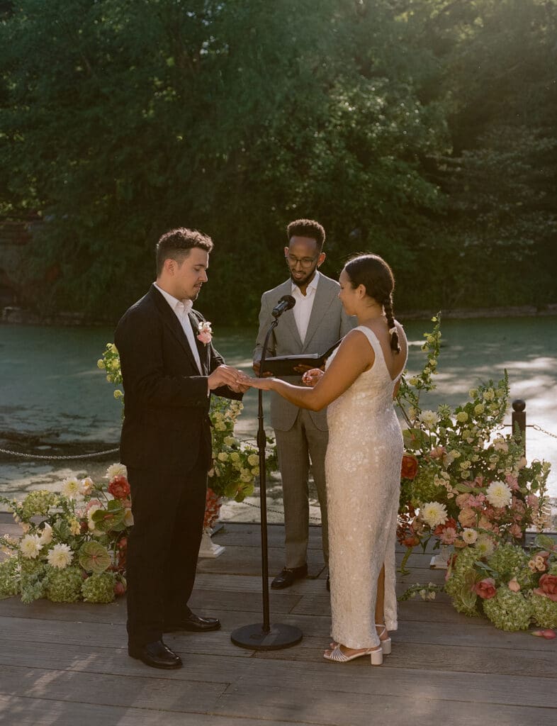 Bride and groom exchanging rings at a prospect park boathouse wedding ceremony