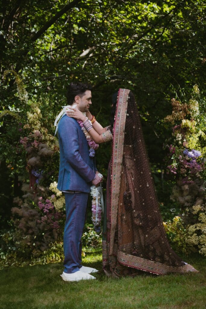 Bride and groom exchanging Indian wedding garlands