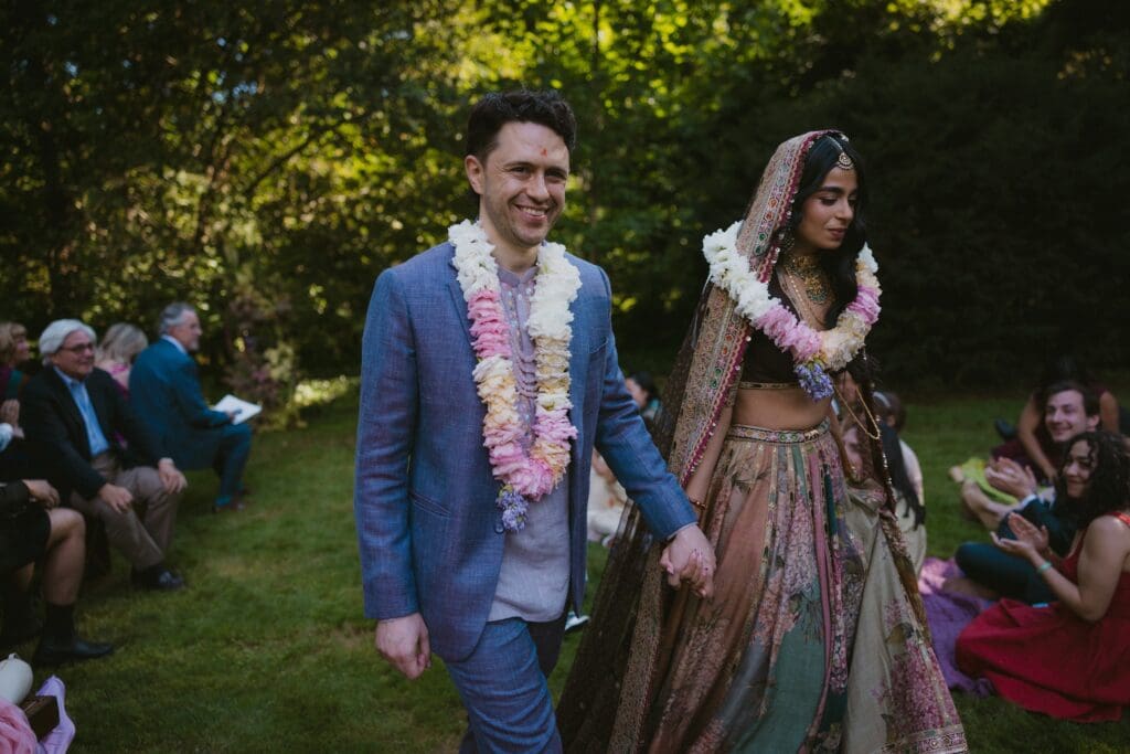 Bride and groom walking back down the aisle after getting officially married 