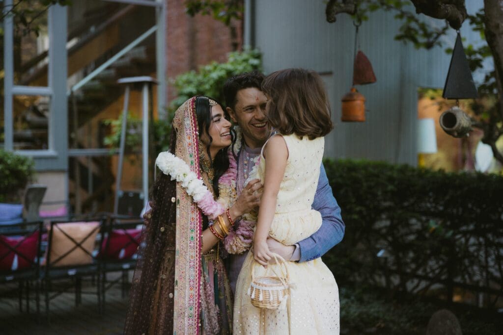 Bride and groom and child laughing together