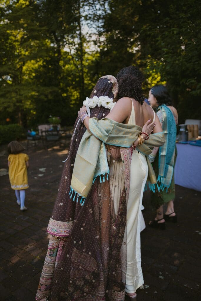 Bride hugging a friend during the wedding reception