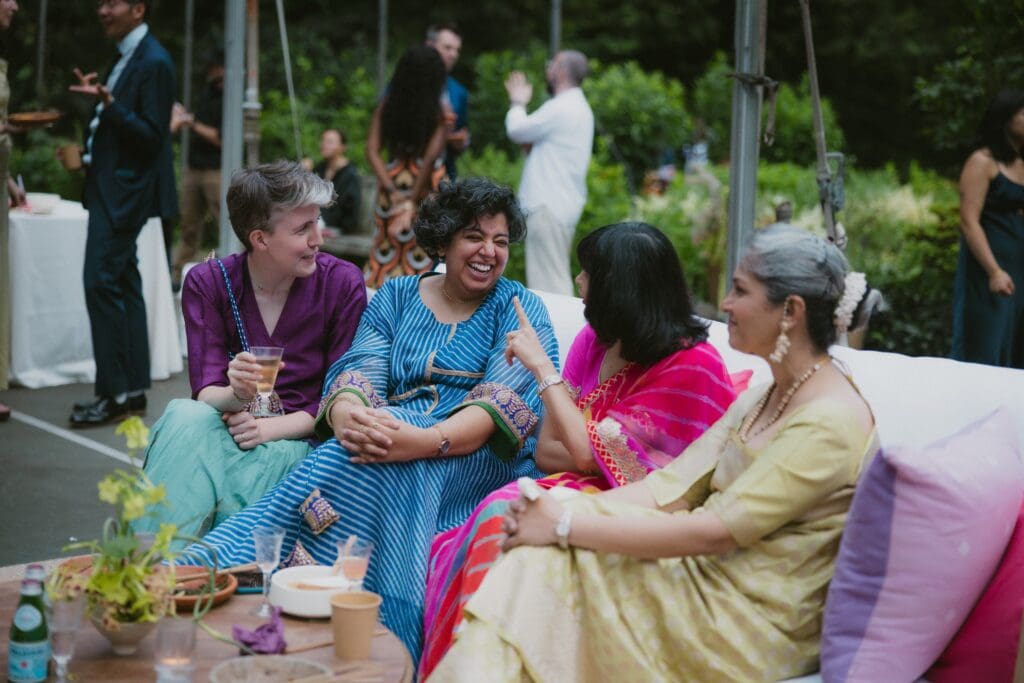 Wedding guests laughing and talking during the reception