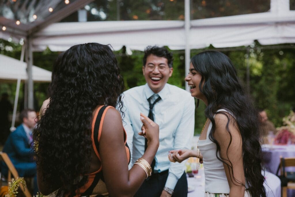 Bride laughing with wedding guests during the reception
