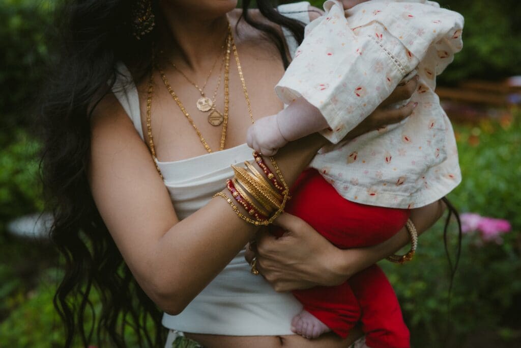 Close up of bride holding a baby during the reception