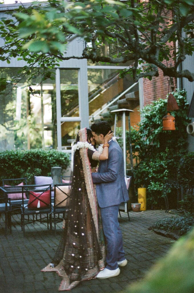 Bride and groom kissing portrait