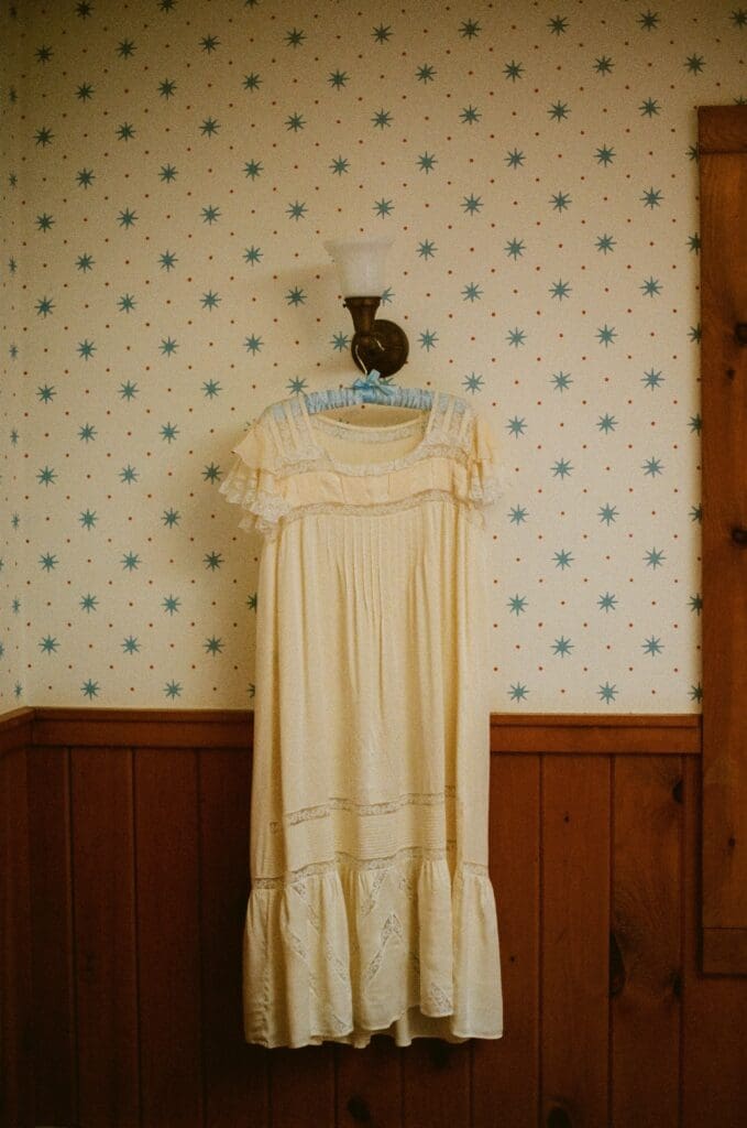 Bride's vintage getting ready nightgown hanging on a sconce 