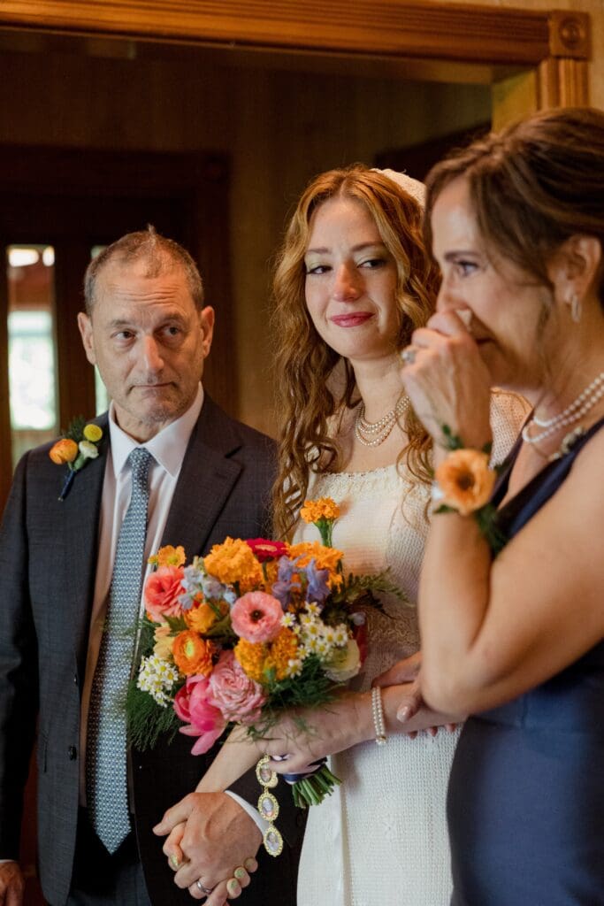 Mother of the bride crying before walking down the aisle