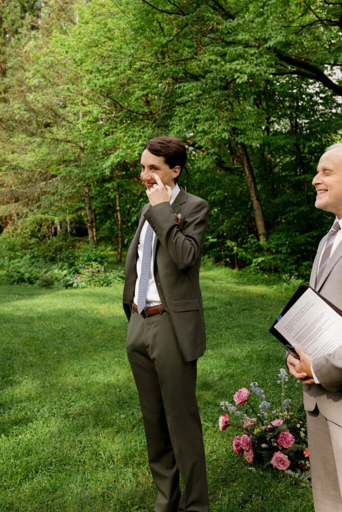Groom crying after seeing the bride start to walk down the aisle