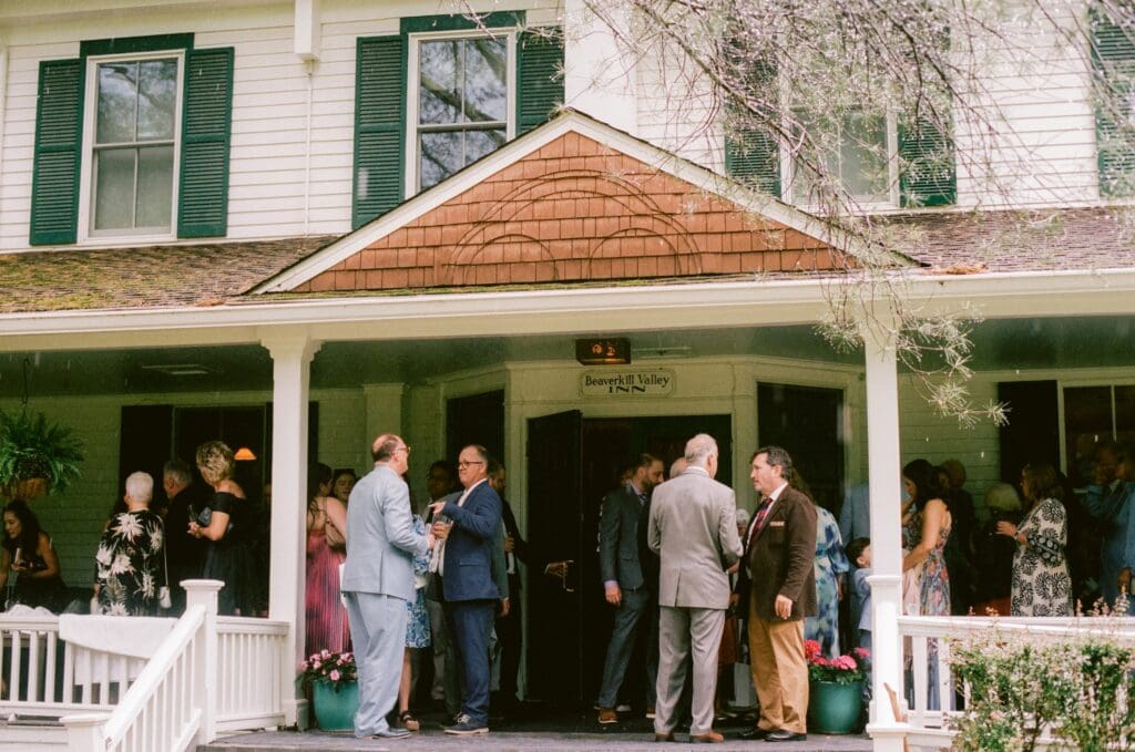 Wedding guests hanging out on the porch of Beaverkill Valley Inn