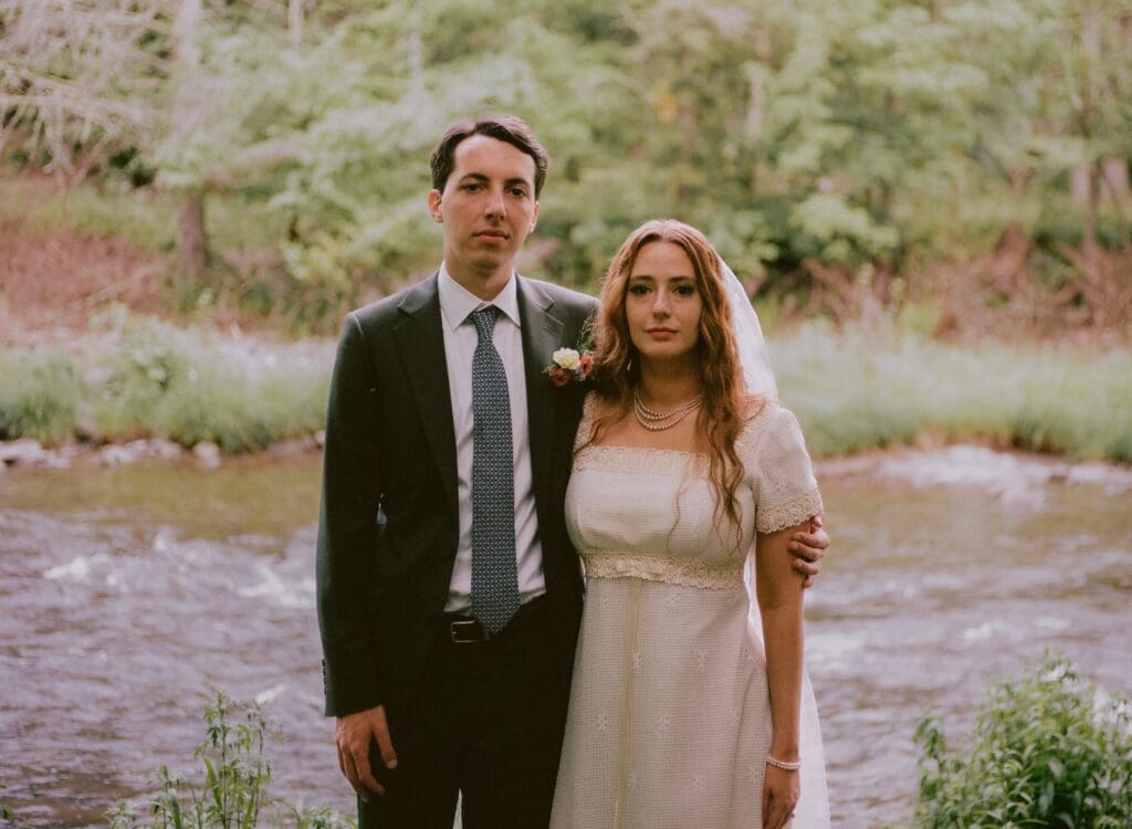 Formal portrait of the bride and groom looking at the camera 