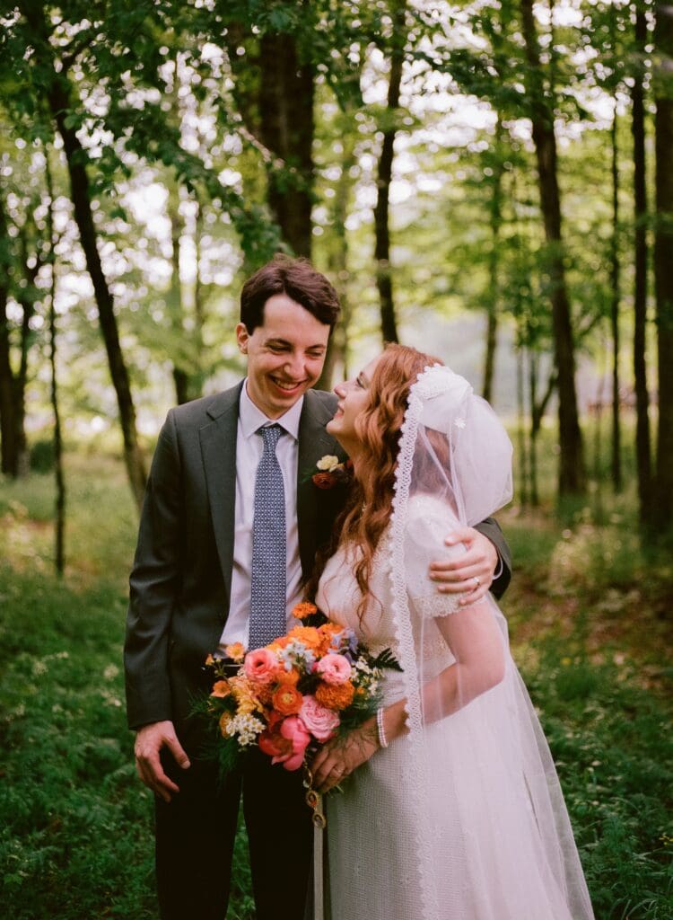 Bride and groom laughing with each other