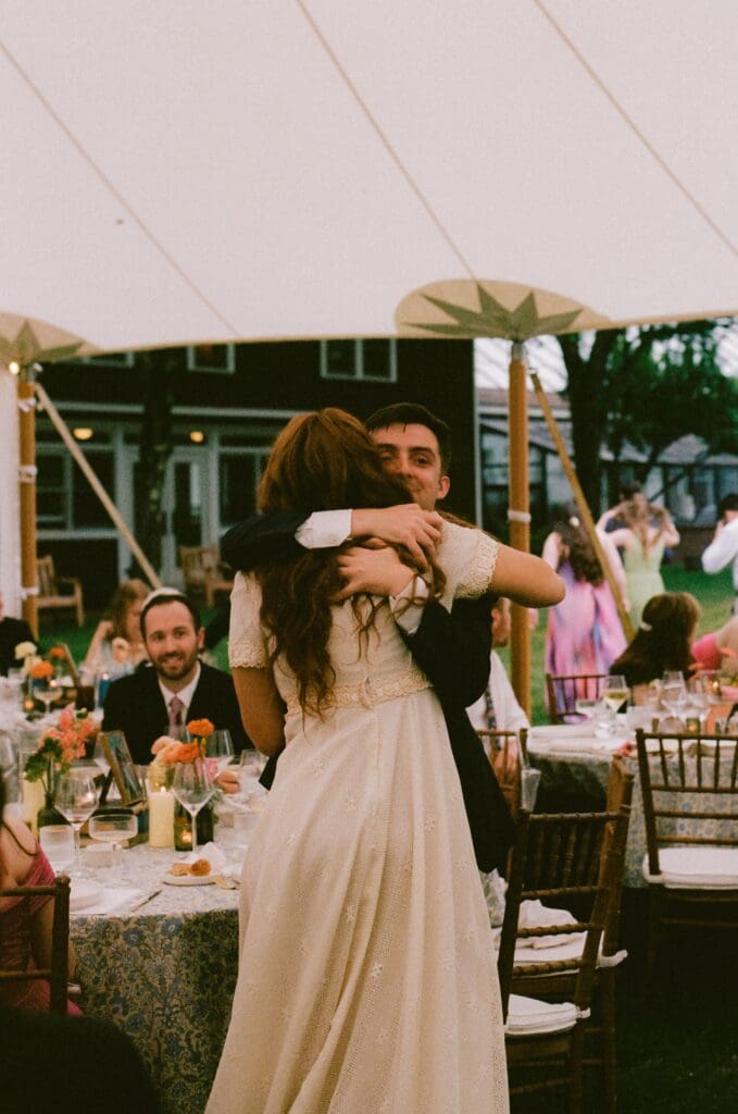 Bride hugging a wedding guest during the reception