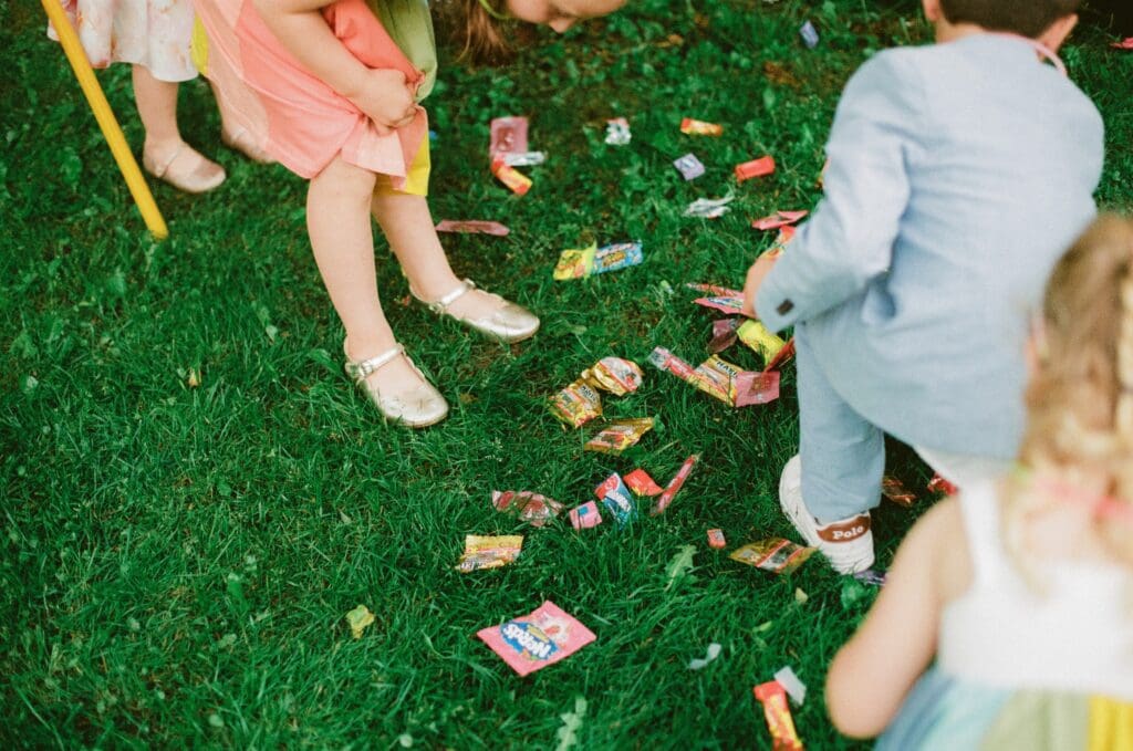 Kids picking up candy from the pinata