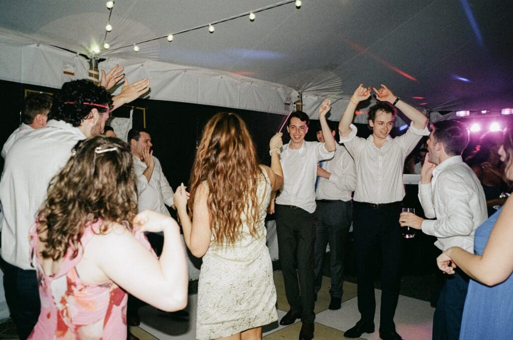 Bride and groom dancing with their guests on the dance floor