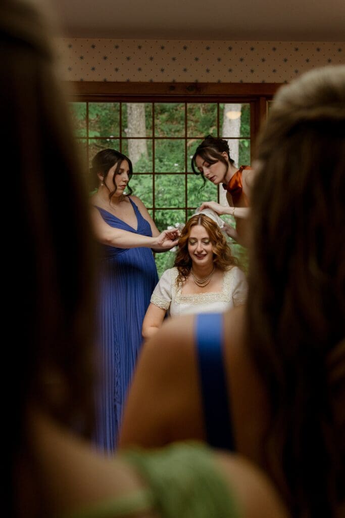Bride getting ready with the help of her bridesmaids