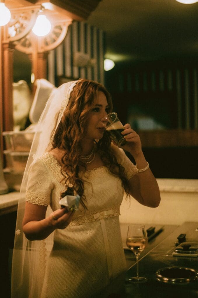 Bride eating ice cream and drinking a soda in an old-fashioned ice cream bar