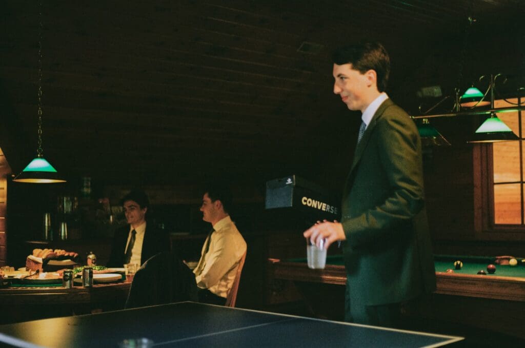 Groom hanging out with the groomsmen in the morning