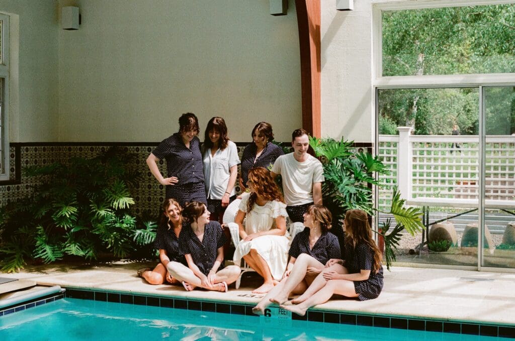 Bridal party candid group photo by the pool