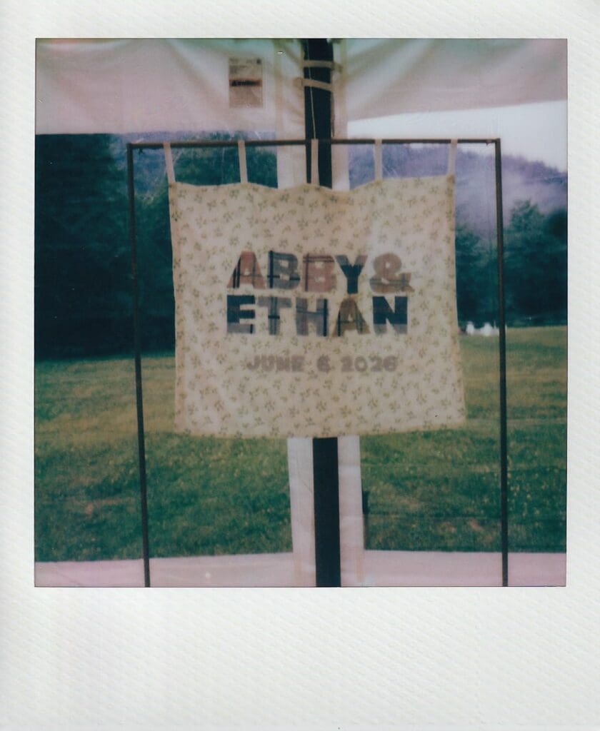 Polaroid of a homemade fabric wedding sign