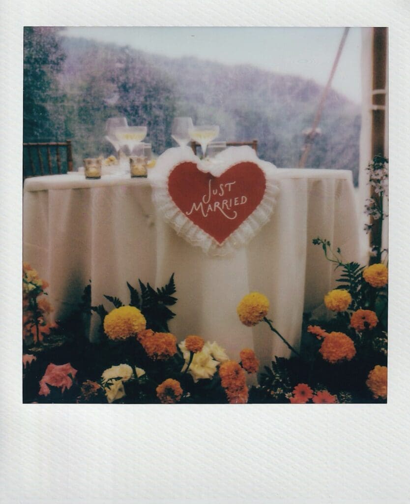 Polaroid of a just married sign on a sweetheart table