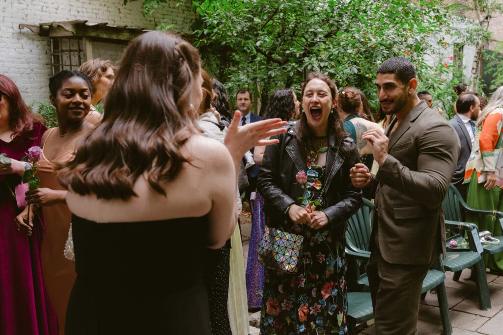 Bride excitedly saying hello to wedding guests 