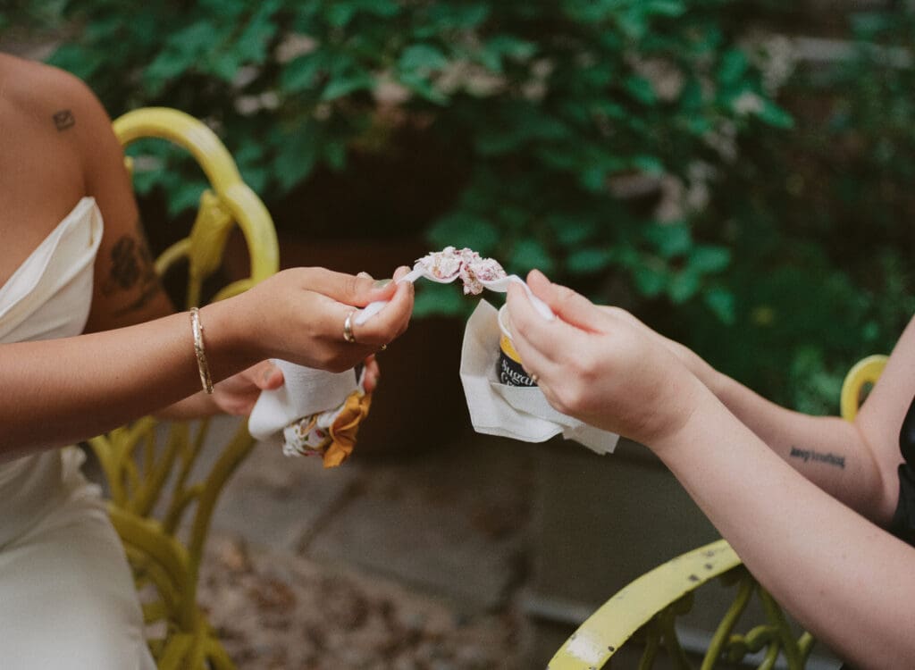 Brides cheersing with spoons of ice cream