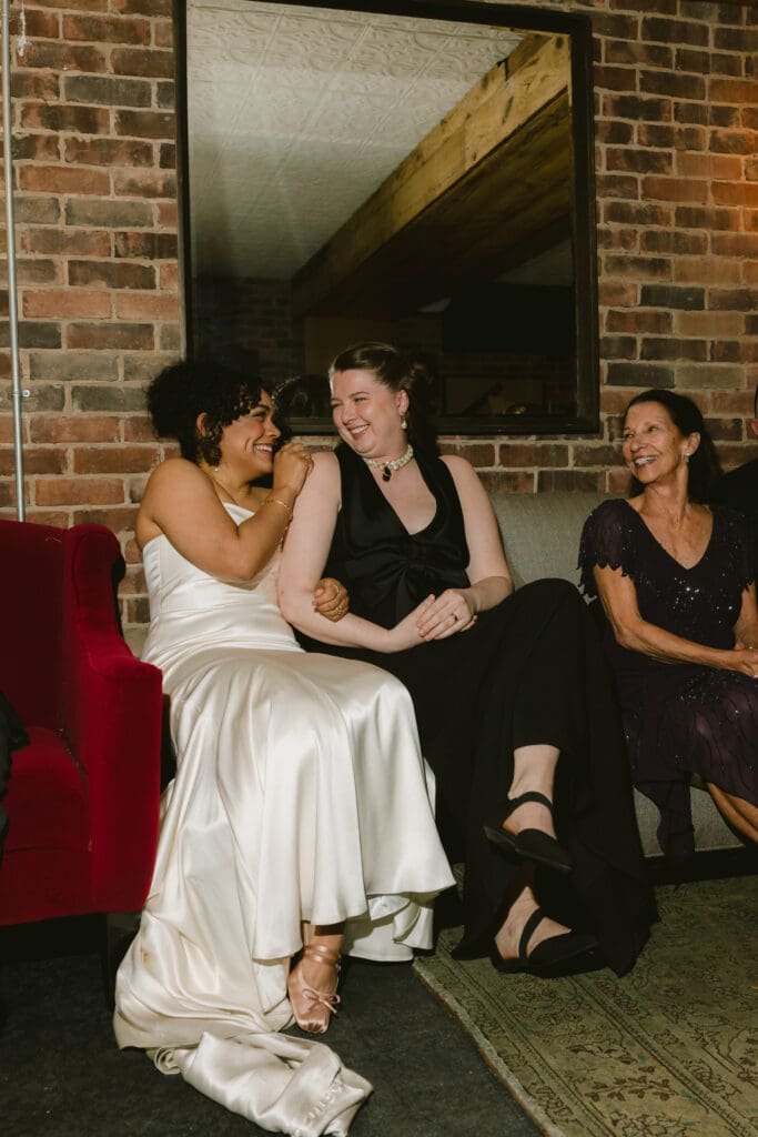 Brides laughing during a toast