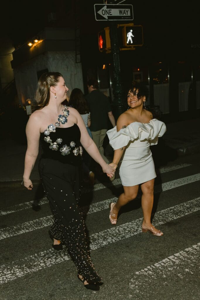 Brides smiling and crossing the street at night in the second looks
