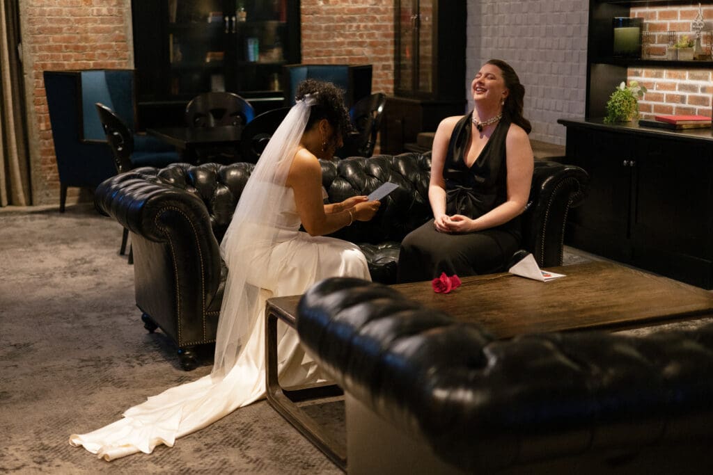 Brides laughing during private vows