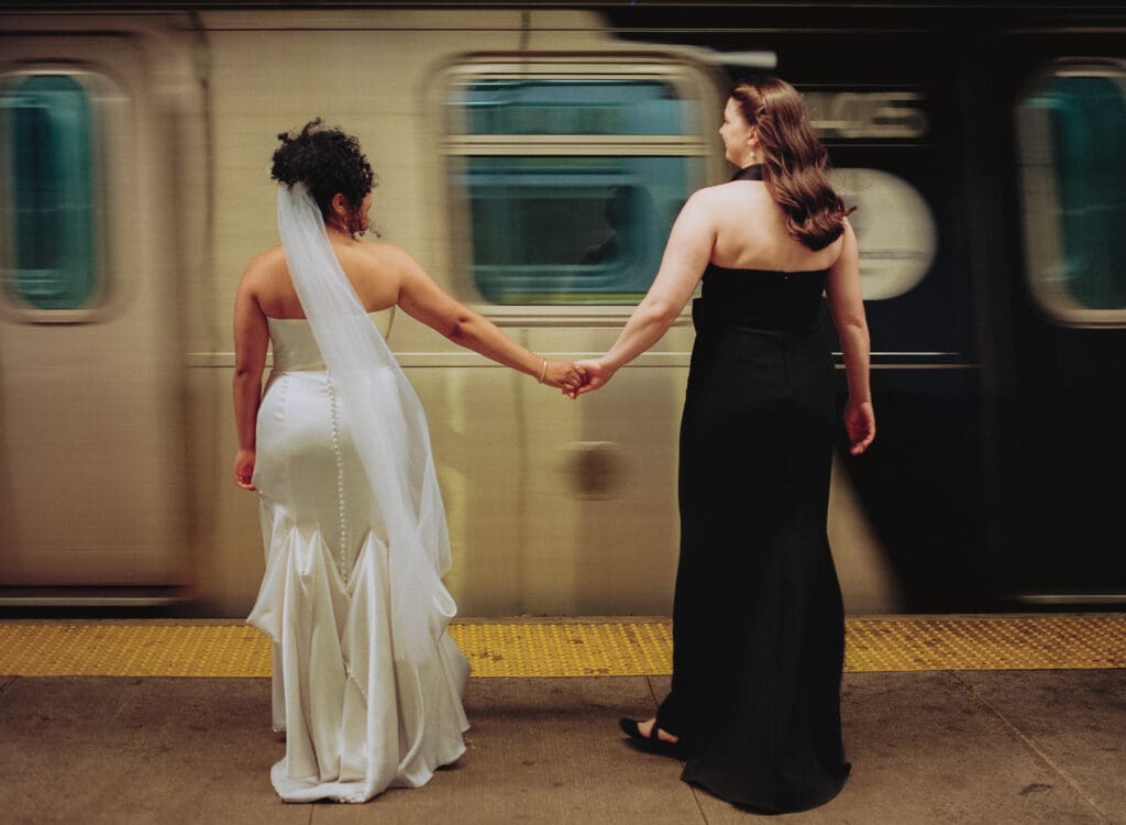Brides standing in front of a moving train in the subway station