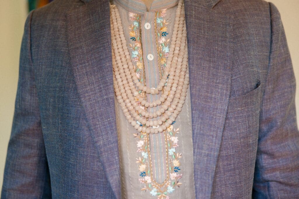 Groom's Indian formal attire under suit jacket 