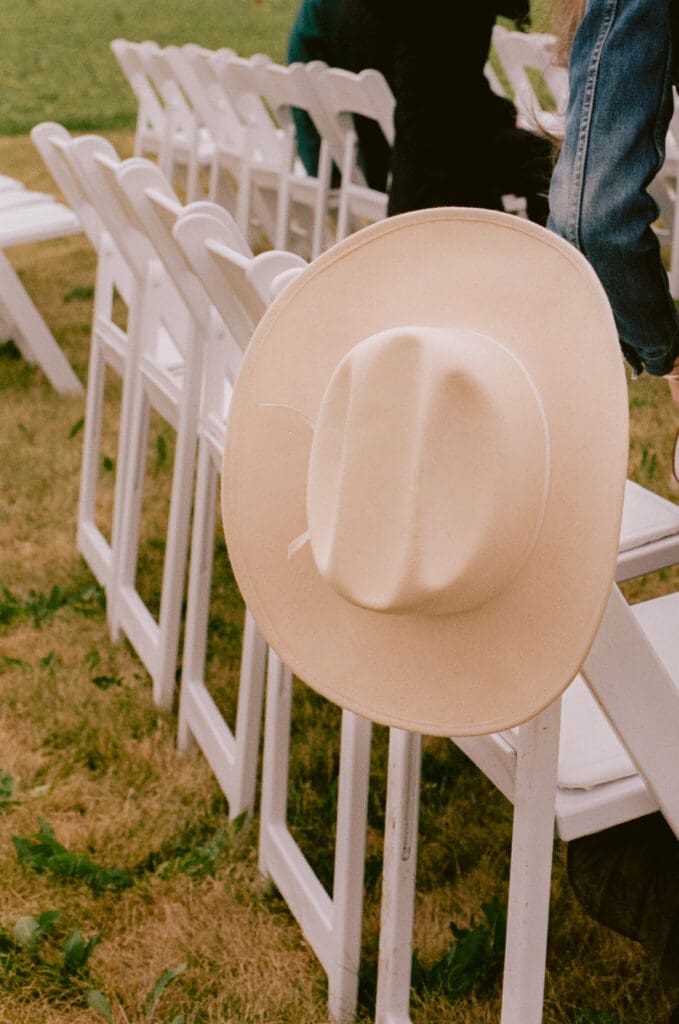 Close up of a cowboy hat hanging off a ceremony chair