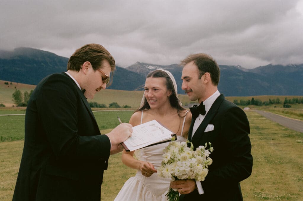 Bride and groom signing the marriage license