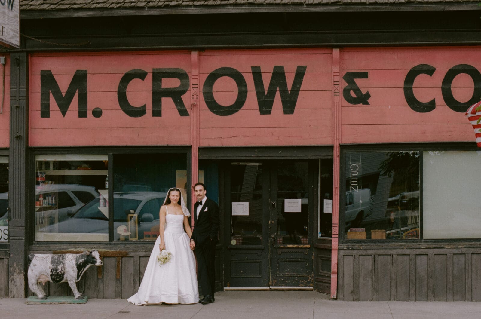 Bride and groom standing in front of their reception restaurant at a western mountain wedding