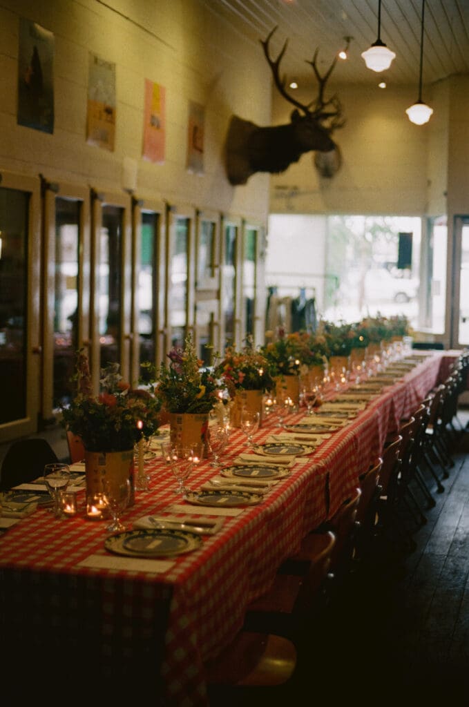 Reception dinner space in a general store at a western mountain wedding