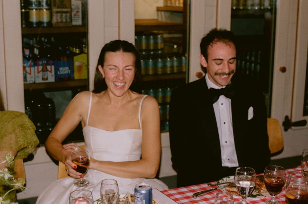 bride and groom laughing during toasts