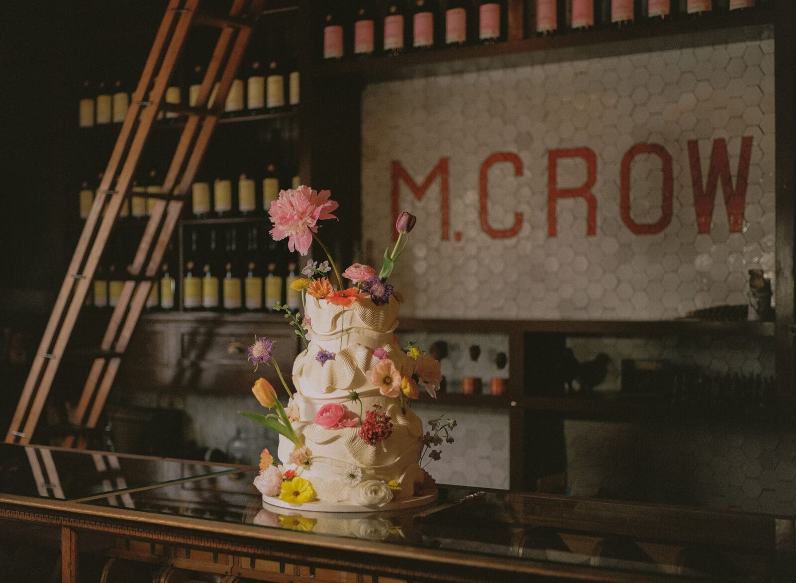 Three tiered wedding cake covered in flowers