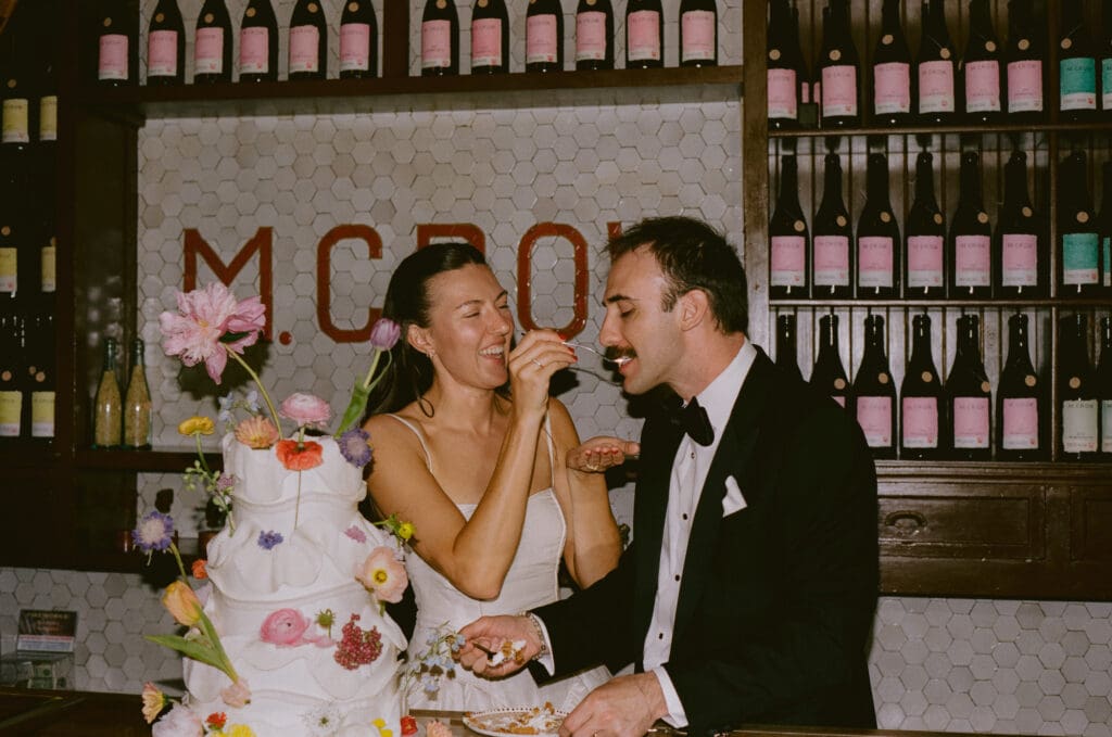 Bride feeding the groom cake after cutting it