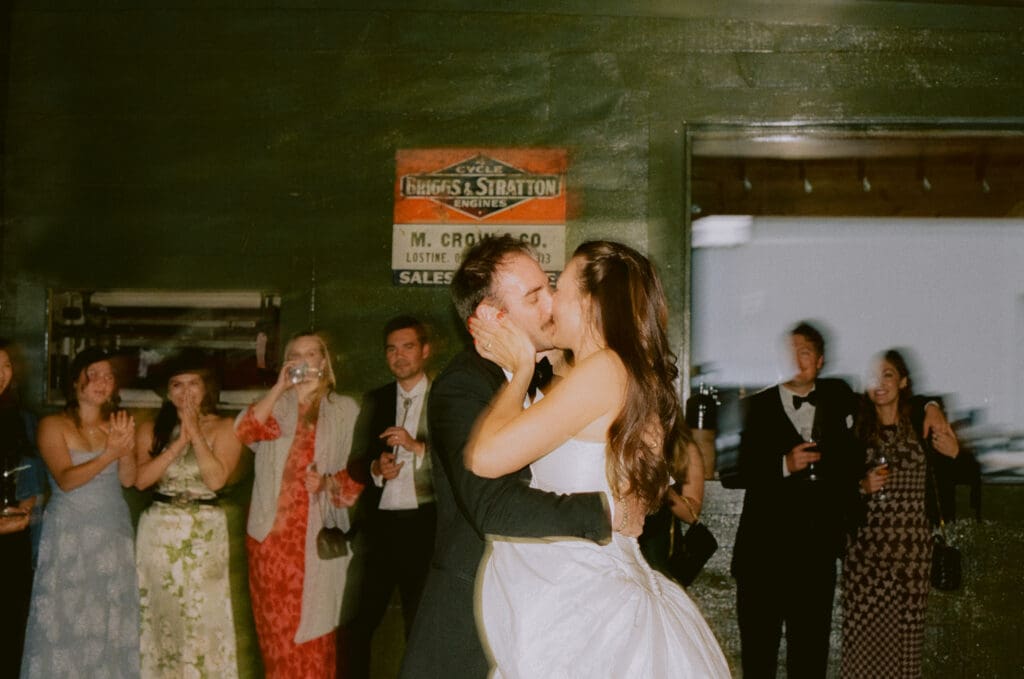 Bride and groom kissing on the dance floor during their first dance